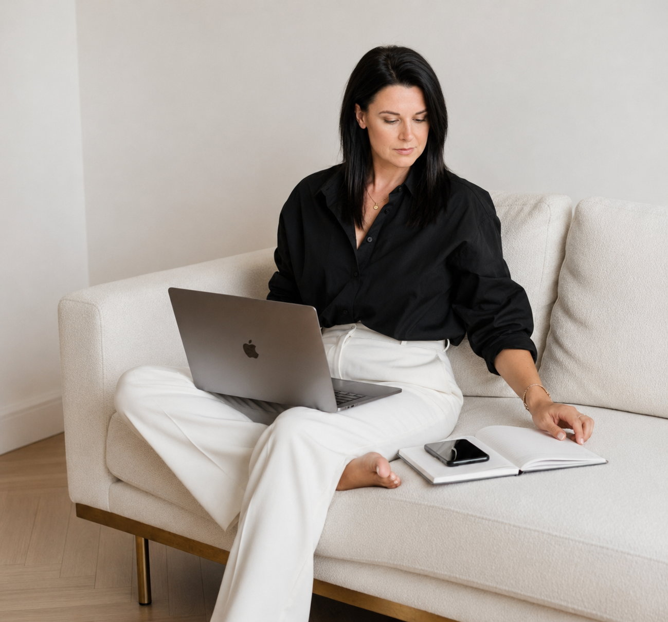Katie Lyth, wedding business strategist, working on her laptop — 1:1 coaching for wedding professionals